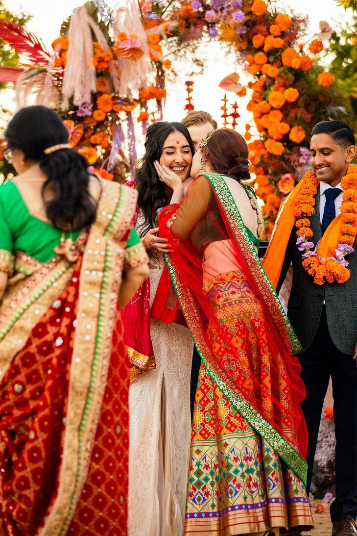 Family Member in Sari Kisses Bride on Cheek During Colorful Indian-Persian Fusion Wedding Ceremony
