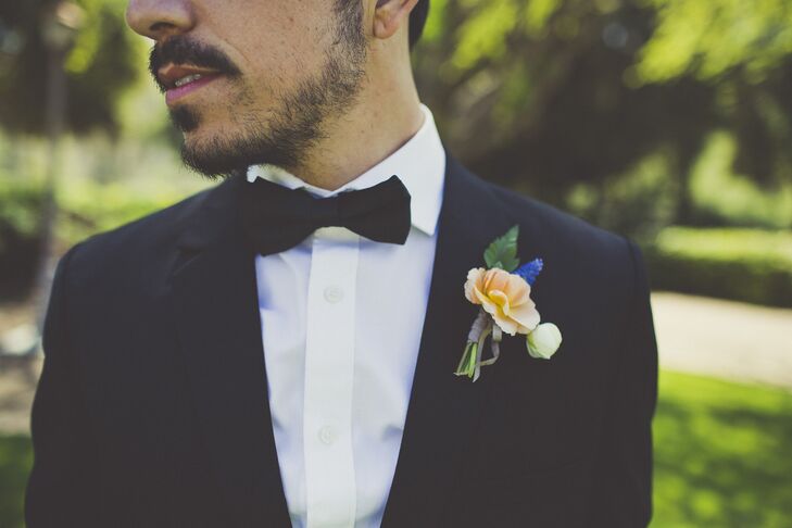 Clay wore a classic tuxedo to complement the elegant style of the wedding. A peach and lavender boutonniere added a hint of color to his ensemble.