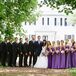 Jennifer's bridesmaids wore floor length purple dresses, and her maid of honor wore the same dress in a slightly darker shade of purple. The groomsmen wore gray suits with matching purple ties.