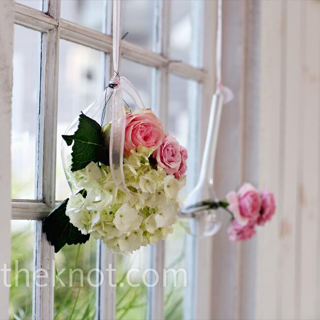 Hanging arrangements of the blooms used in the bridesmaid bouquets decorated the inside of the boathouse chapel.