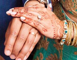 Bride with a diamond engagement ring and groom with wedding ring