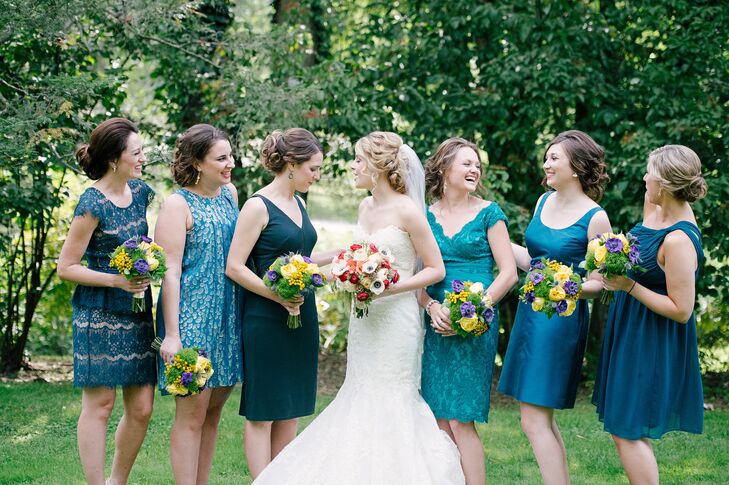 Bridesmaids were dressed in different shades of blue, meant to compliment the peacock accented floral arrangements. Each dress was different in color, style and length.