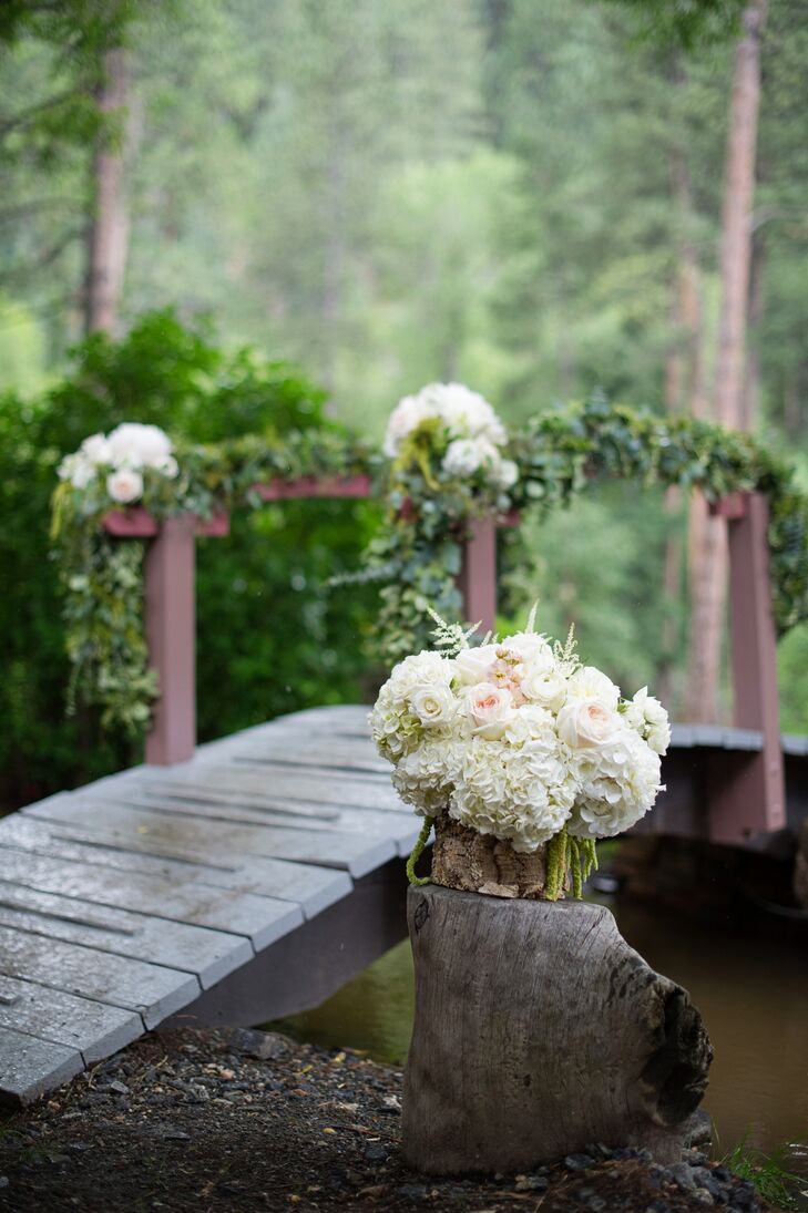 The walk to the ceremony gazebo included a small wooden bridge flanked by lush arrangements of ivory hydrangeas.