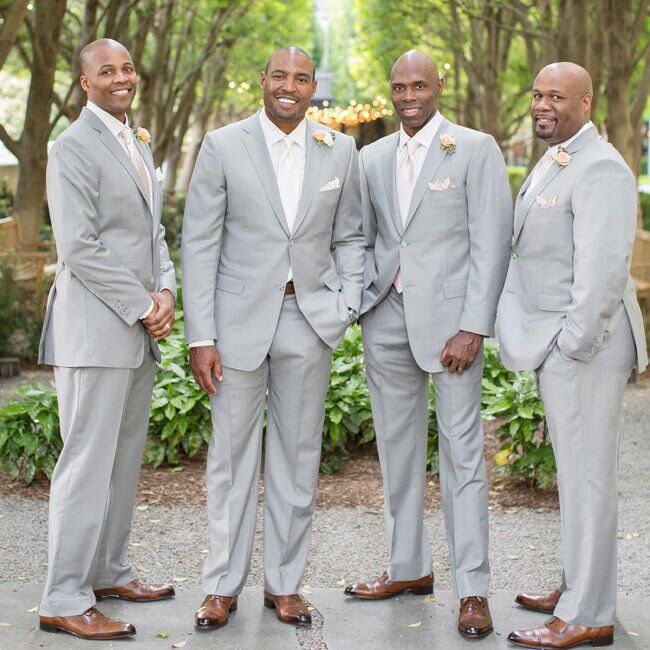 Groomsmen matched the groom in light gray suits accented with white ties and pocket squares.