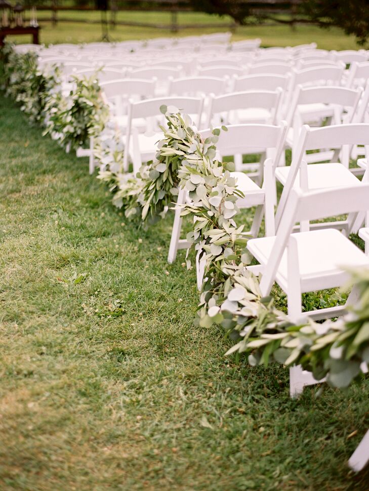 Lush green garlands of eucalyptus and olive leaves lined the ceremony aisle. Each garland was repurposed for the reception, adding a fresh, organic touch to the tabletops.