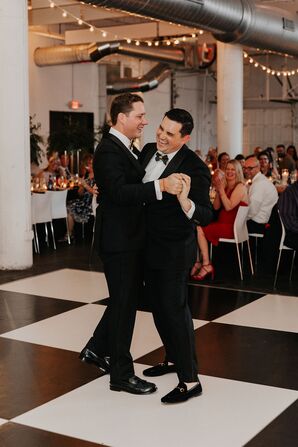 New Husbands Sharing a First Dance on Checkered Dance Floor in Matching Tuxes