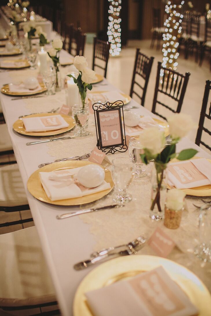 Gold chargers were topped with the couple's maraca favors and set on top of white linens at the reception.