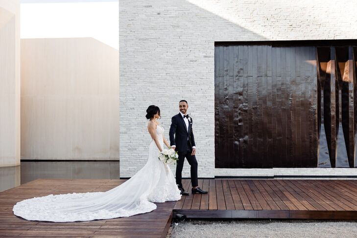 Couple in Black Tie Wedding Attire Walk Hand-in-Hand on Wooden Walkway, NOBU Beach Wedding