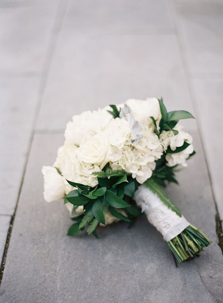 To achieve her dream bouquet of large white blooms, Nina carried ranunculus, garden roses, peonies and hydrangeas along with some greenery and dusty miller. The bridesmaid bouquets were small bouquets of white garden roses and hydrangeas with a bit more greenery than Nina’s, and the boutonnieres consisted of white ranunculus with greenery accents.