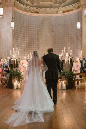 Bride With a Long Veil Walking Into Religious Ceremony By Her Father