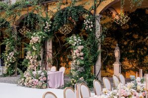 Sweetheart Table Underneath Verdant Floral Arrangement and Climbing Ivy