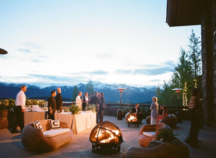 Neutral-colored elegant lounge furniture was placed around cozy fire pits on the porch of the venue overlooking the Teton Mountains and valley. A mariachi band played in the background as guests enjoyed a cocktail hour before the reception.
