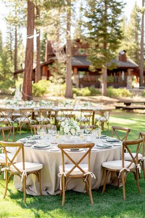 Rustic Reception Tables With Neutral Linens and Wood Cross-Back Chairs on Lawn at Martis Camp in Truckee, California