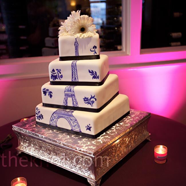 The Eiffel Tower was hand-painted in a deep purple color on the four offset tiers of the cake.