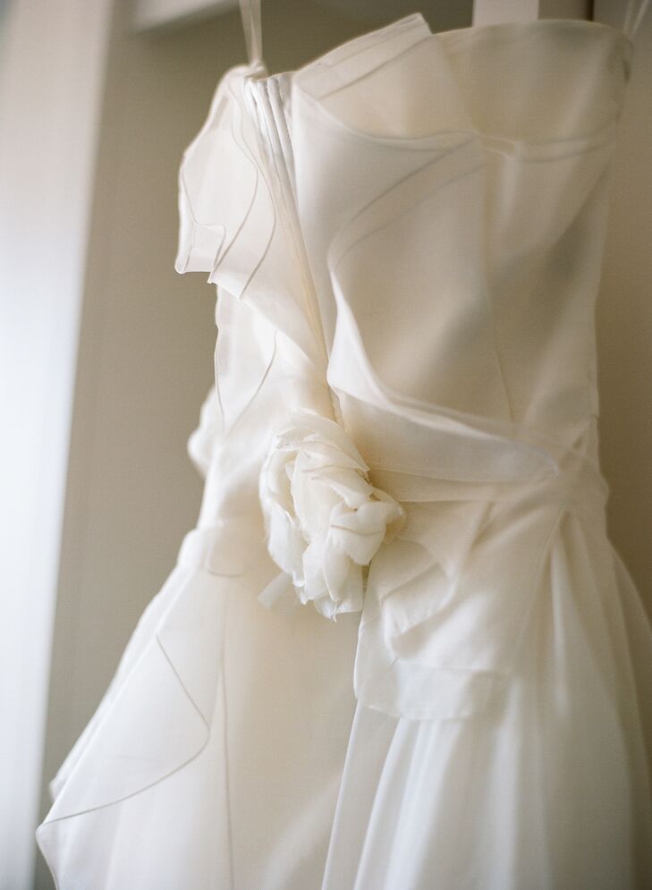"The dress reminded me of a flower with layer upon layer of silk organza peeling back from the center of the bodice, only to sweep forward again," Tessa says. She found this stunning Dolce & Gabbana gown in Paris, France, while she was on a trip with her mother. Although she and Brendan were not engaged, she knew that this was her dress.