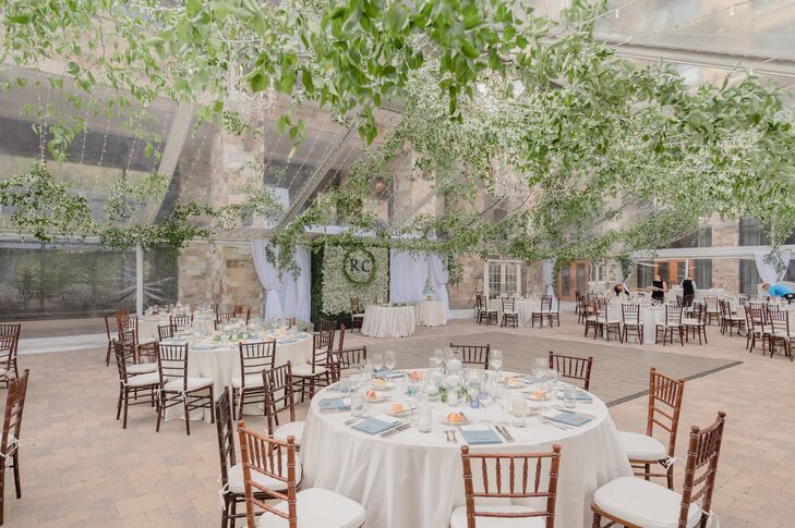 Wedding Reception Decorated With Greenery and Wood Chiavari Chairs