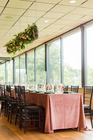 Reception Table With Pink Velvet Linens and Hanging Greenery Installation