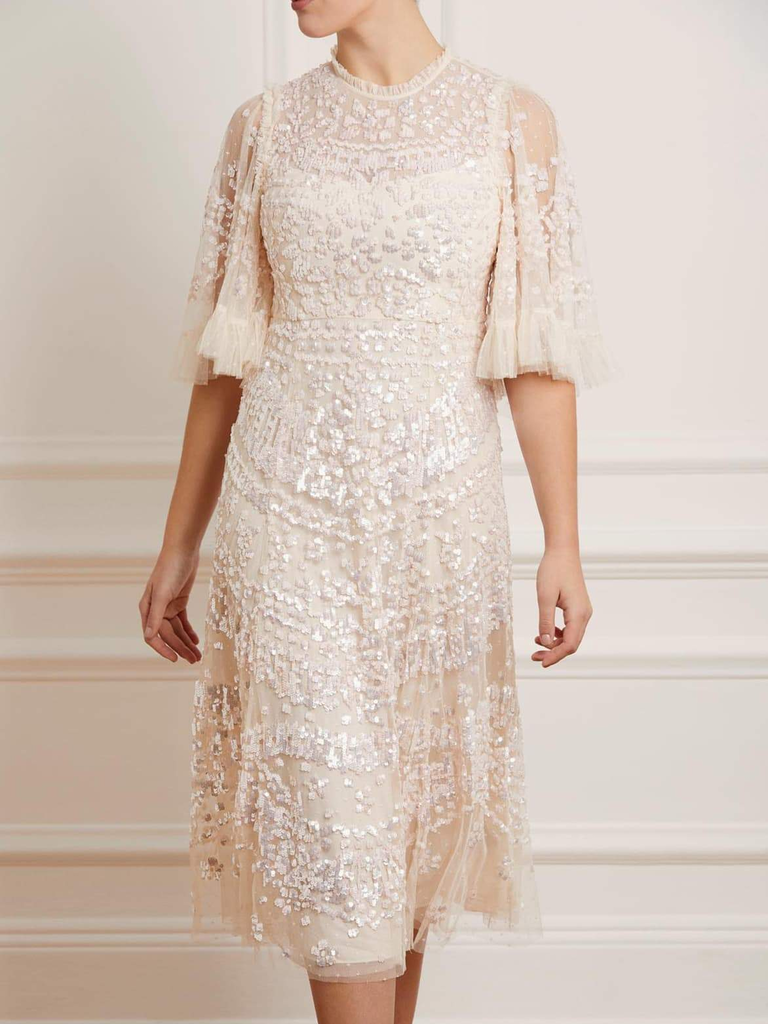 A model shows off this stunning white lace dress.