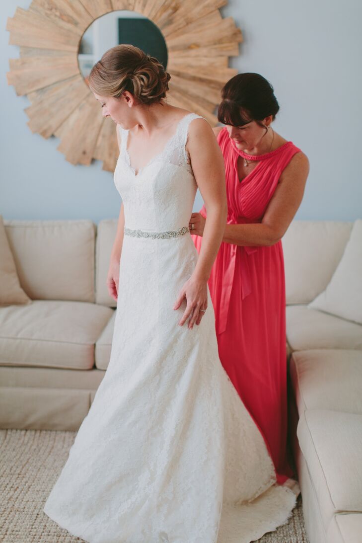 Brittany wore a fit-and-flare lace empire wedding dress with a V-neckline. We love the beaded appliques on the neckline and skirt and elegant beaded belt.
