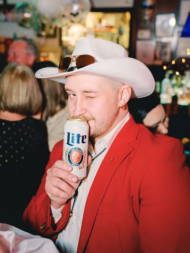 Elopement Party Guest With Cowboy Hat and Red Jacket at Diner