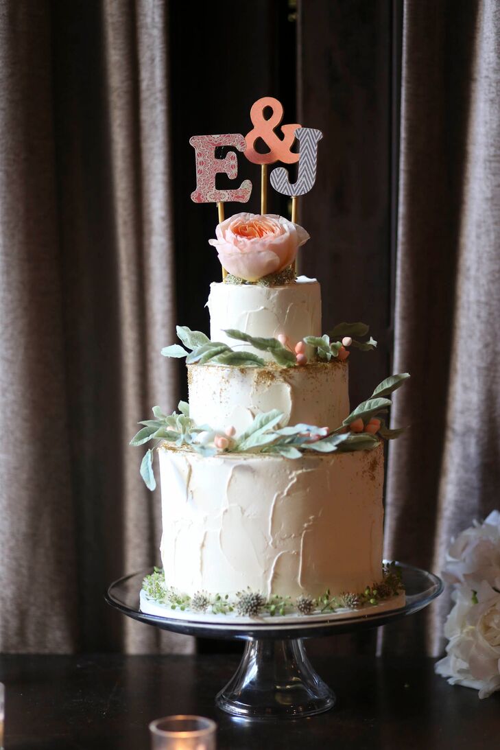 Lael Cakes whipped up a three-tiered, gluten-free and vegan wedding cake for Emma and Jesse’s reception. The confection reflected the decor’s rustic done through textured buttercream frosting and delicate greenery adorning each layer. For a note of playfulness, they topped the cake with an E and J cake topper, each letter displaying a fun, graphic print.