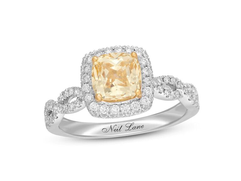 kay neil lane cushion cut natural yellow diamond engagement ring with round diamond halo diamond encrusted twisted sides and plain white gold band