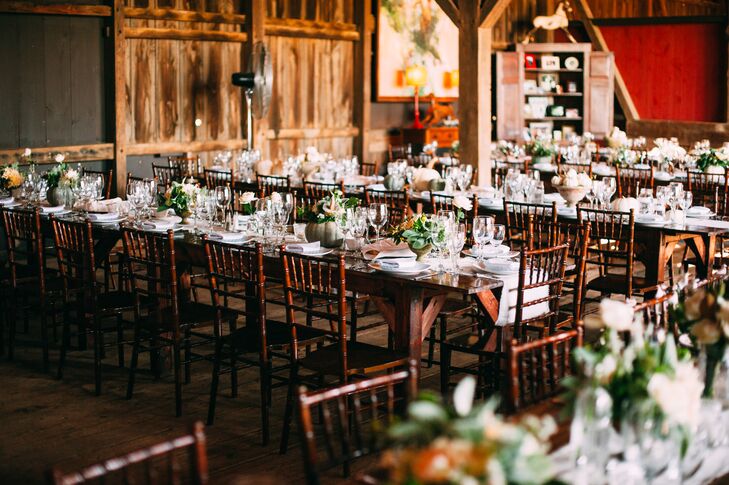 The reception was held in a barn at Riverside on the Potomac in Leesburg, Virginia. A family style meal catered by Culinary Delights by Feist was served on farmhouse style tables set with brown chiavari chairs.