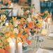 Elegant Rehearsal Dinner Table With Vibrant Flower Centerpieces and Taper Candles