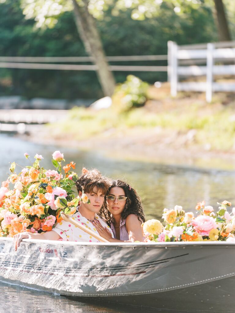 couple in rowboat surrounded by flowers