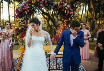 Bride and groom crying walking away from altar
