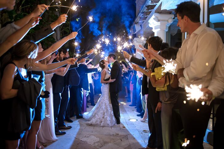 Derek and his groomsmen wore classic black tuxedos and white rose boutonnieres for the couple's traditional ceremony. For a fun touch, the groom stood out with a black-and-white polka-dot tie.