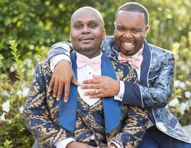 Cute couple smiling wearing pink wedding bow ties