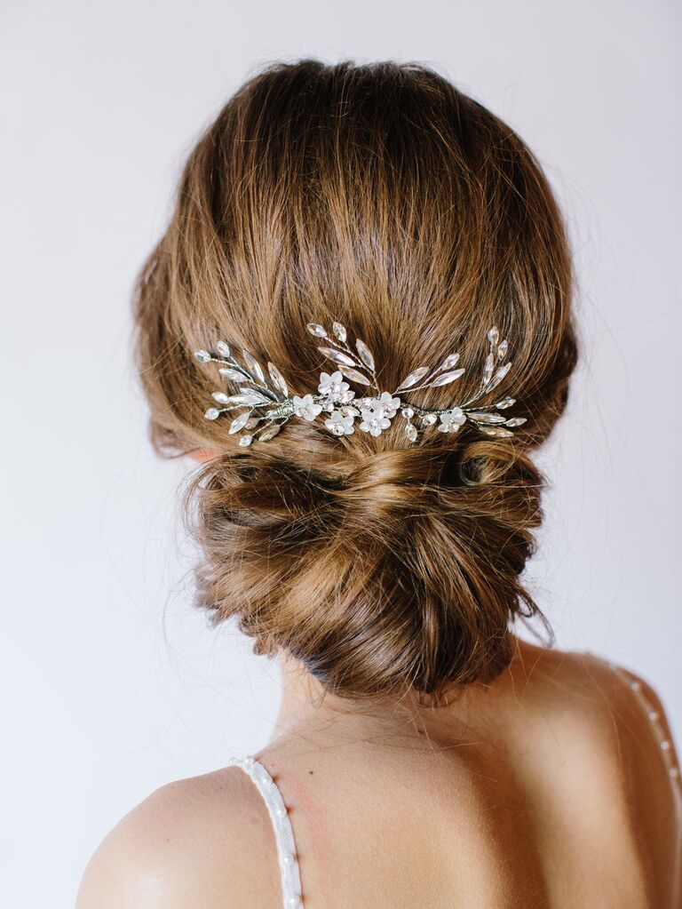 Beautiful floral hairpiece in bride's updo. 