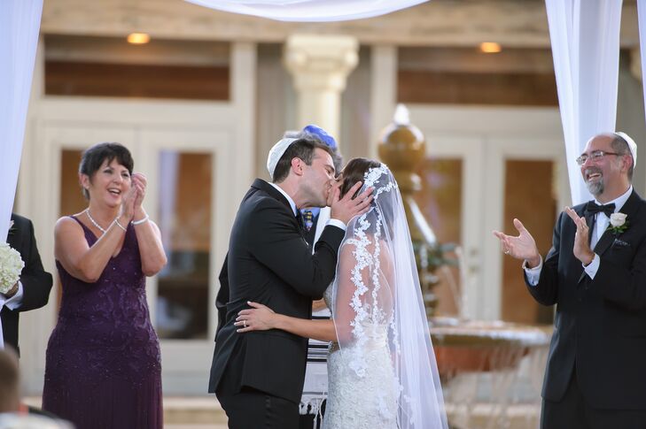 Melissa paired her stunning white and neutral lace wedding dress from Bijou Bridal with just the right accessories. She paired the white lace with a simple fingertip-length lace-trimmed veil and a matching hair comb in her side-swept hairstyle.