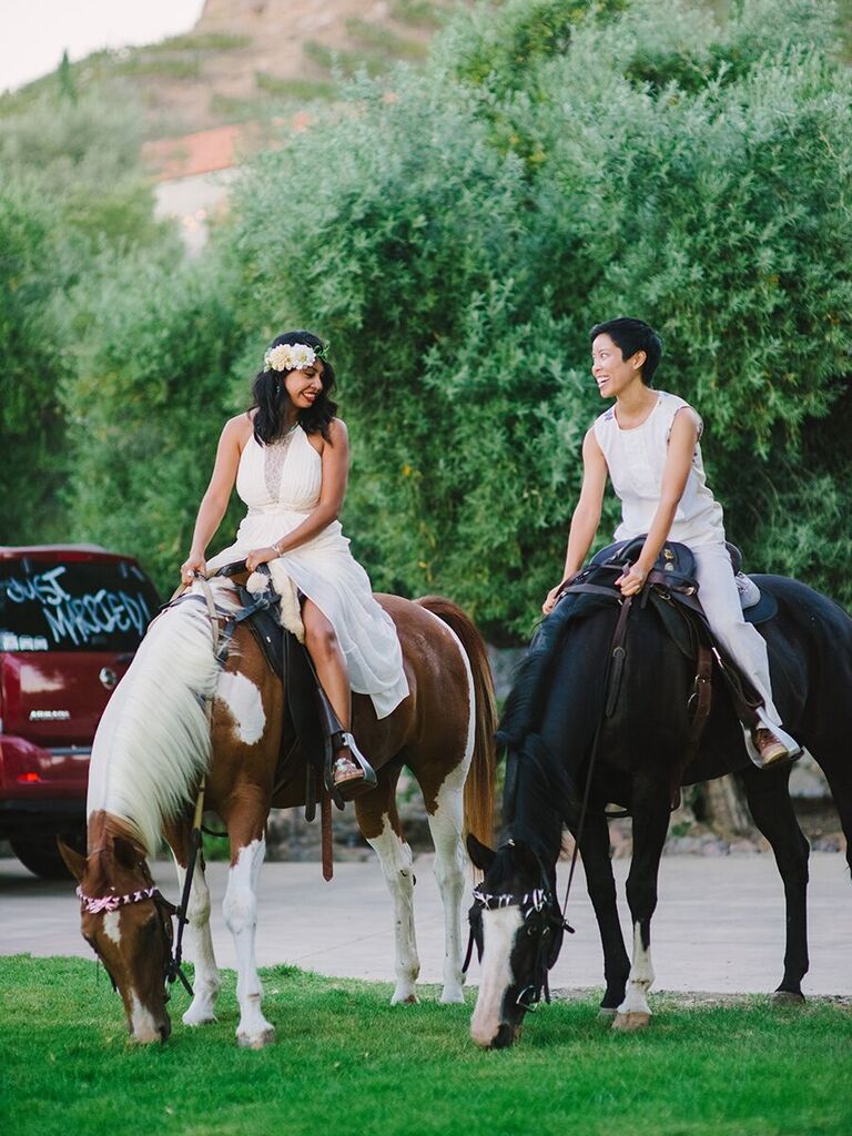 Brides riding horseback for their reception grand entrance. 