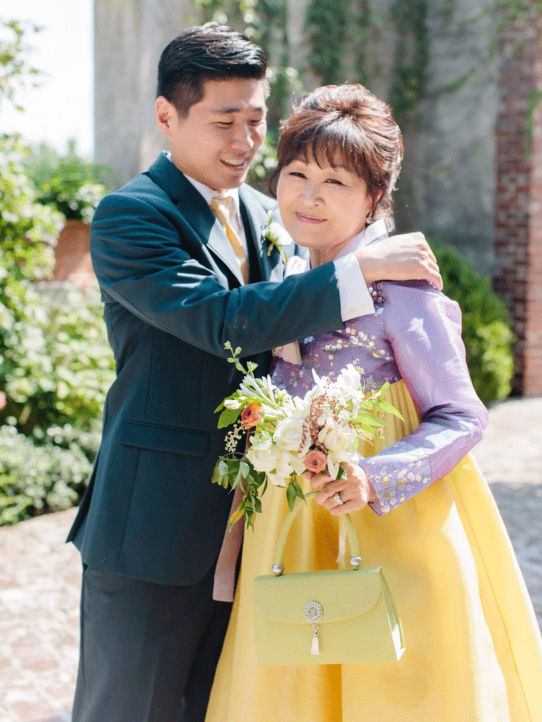 Mother of the groom and groom hugging each other. 