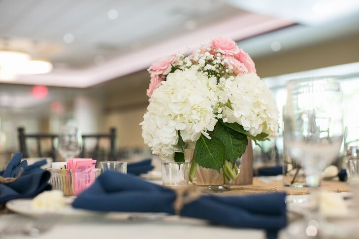 Ivory hydrangea, pink rose and baby's breath flower centerpieces were positioned on dining tables inside the Reception Hall at Ohio State University.