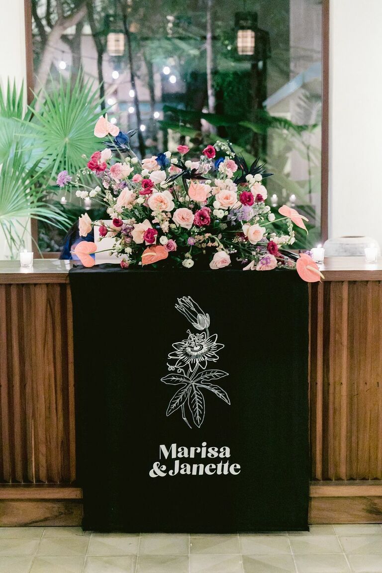 Modern black fabric sign and colorful floral arrangement 