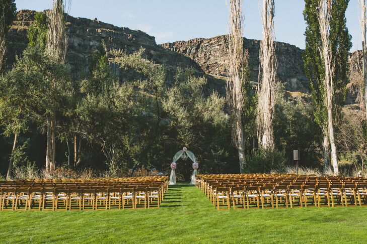 The red rocks in the background accented the outdoor ceremony where Elle and Kalen were married under an archway. It was decorated with blush and ivory flowers and a chandelier.