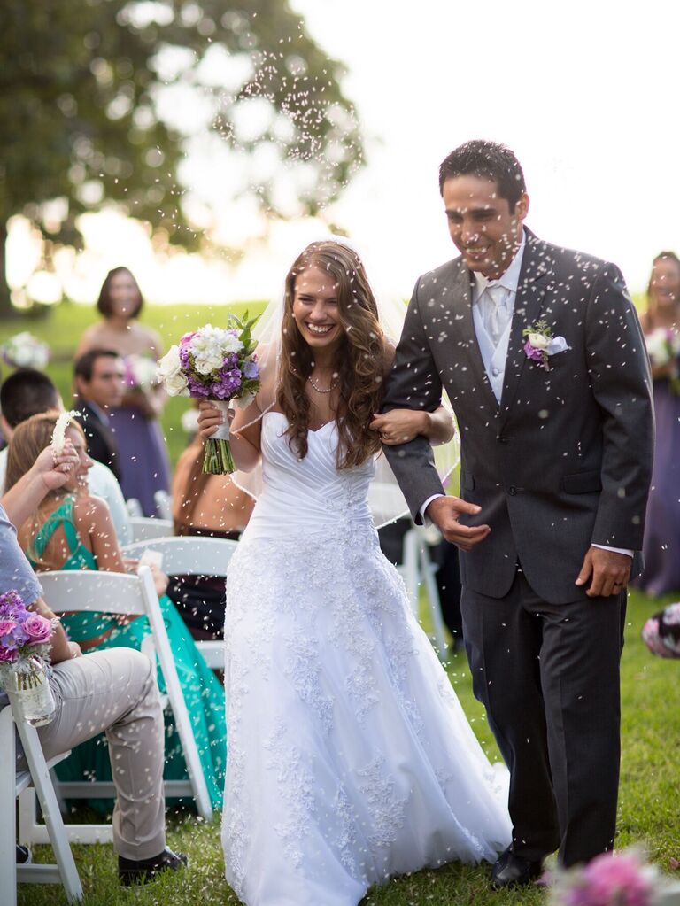 Bride and groom walk through rice toss at the end of the ceremony. 