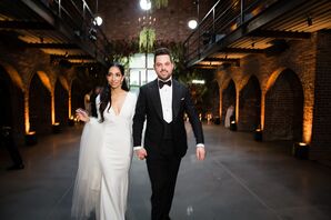Modern Couple with Sleek Long-Sleeved Wedding Dress and Classic Black Tuxedo