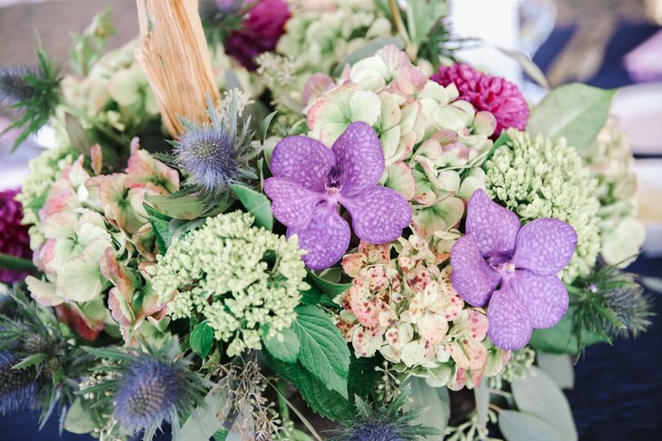Lavender orchids, greens and succulents sat at the center of each reception table.