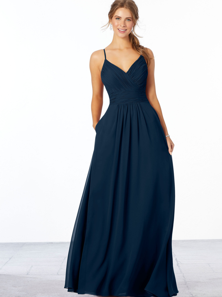 A model shows off a spaghetti strap bridesmaid dress with a ruched bodice.