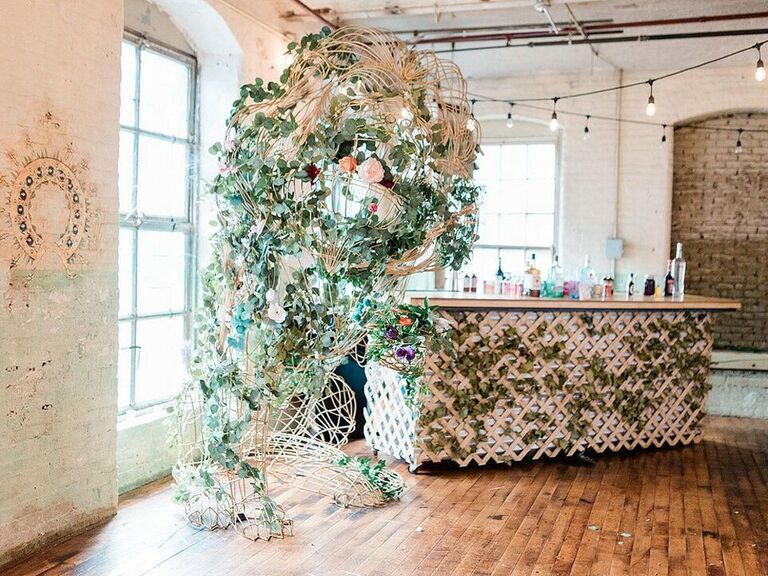 Vintage bar with trellis covered in ivy with greenery installation