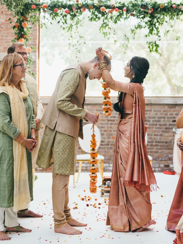 Bride wearing a peach saree that matches her wedding color scheme.