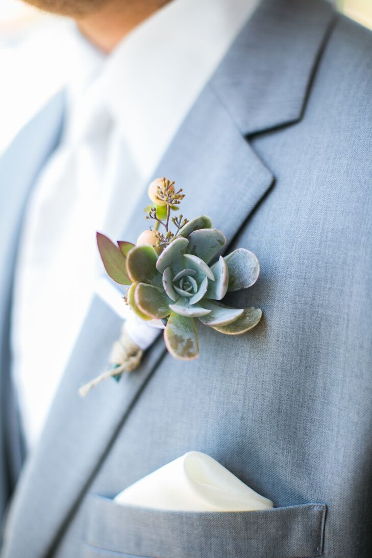 Nate's succulent boutonniere matched his light gray suit, while peach hypericum berries added a classic Georgian touch.