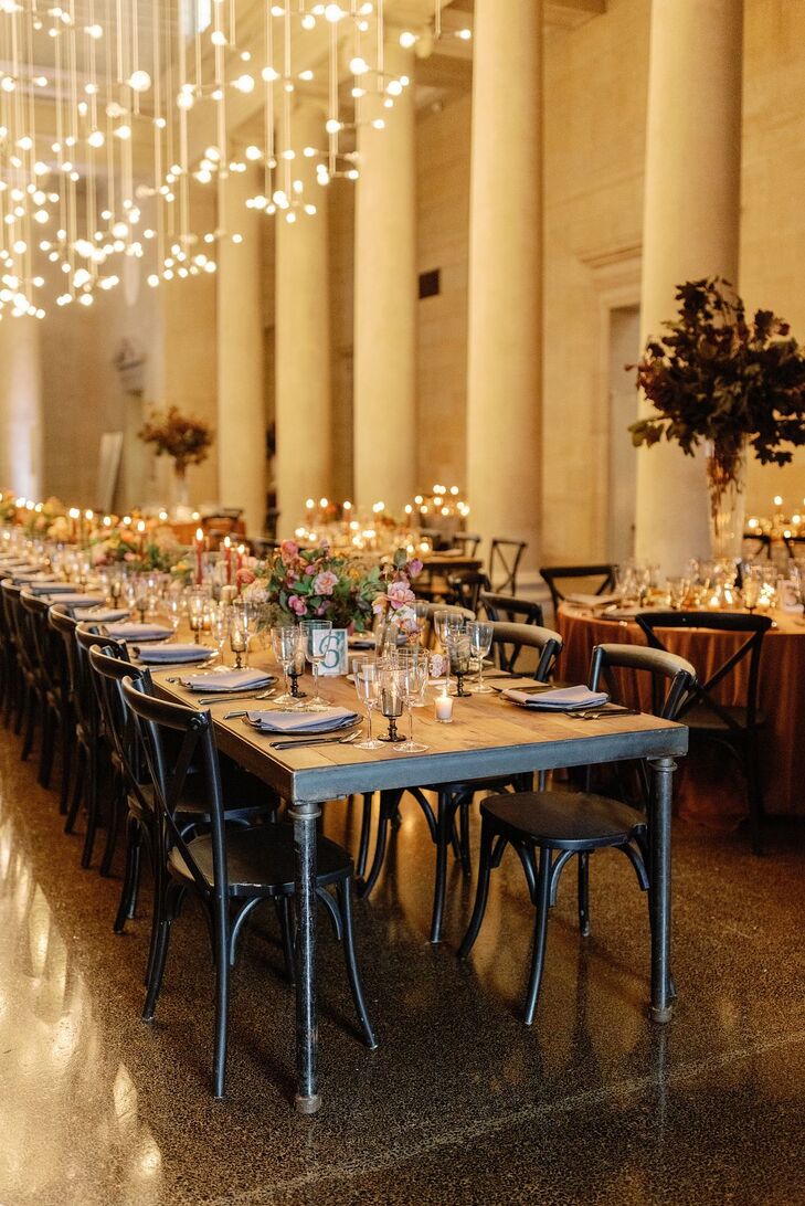 Long Reception Table With Low Centerpieces, Candles Under Light Installation