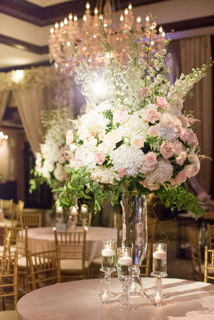 Tall, opulent arrangements of hydrangeas, roses and stock and sparkling chandeliers infused the spacious ballroom at the Dallas Country Club with an element of botanical elegance, while flickering candlelight and blush linens grounded the decor in romantic territory.