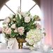 The reception tables were decorated with classic gold vases filled with garden-inspired arrangements including blush roses, blush sweet peas, pink tulips and white hydrangeas along with greenery. The centerpieces were accented with small votives candle for some added romance.