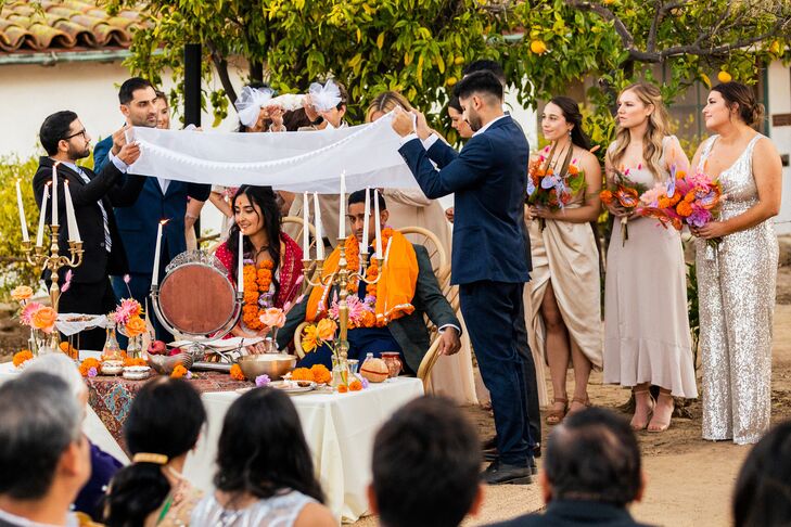 Couple Seated Under Veil at Sofreh Aghd During Persian Wedding Ceremony